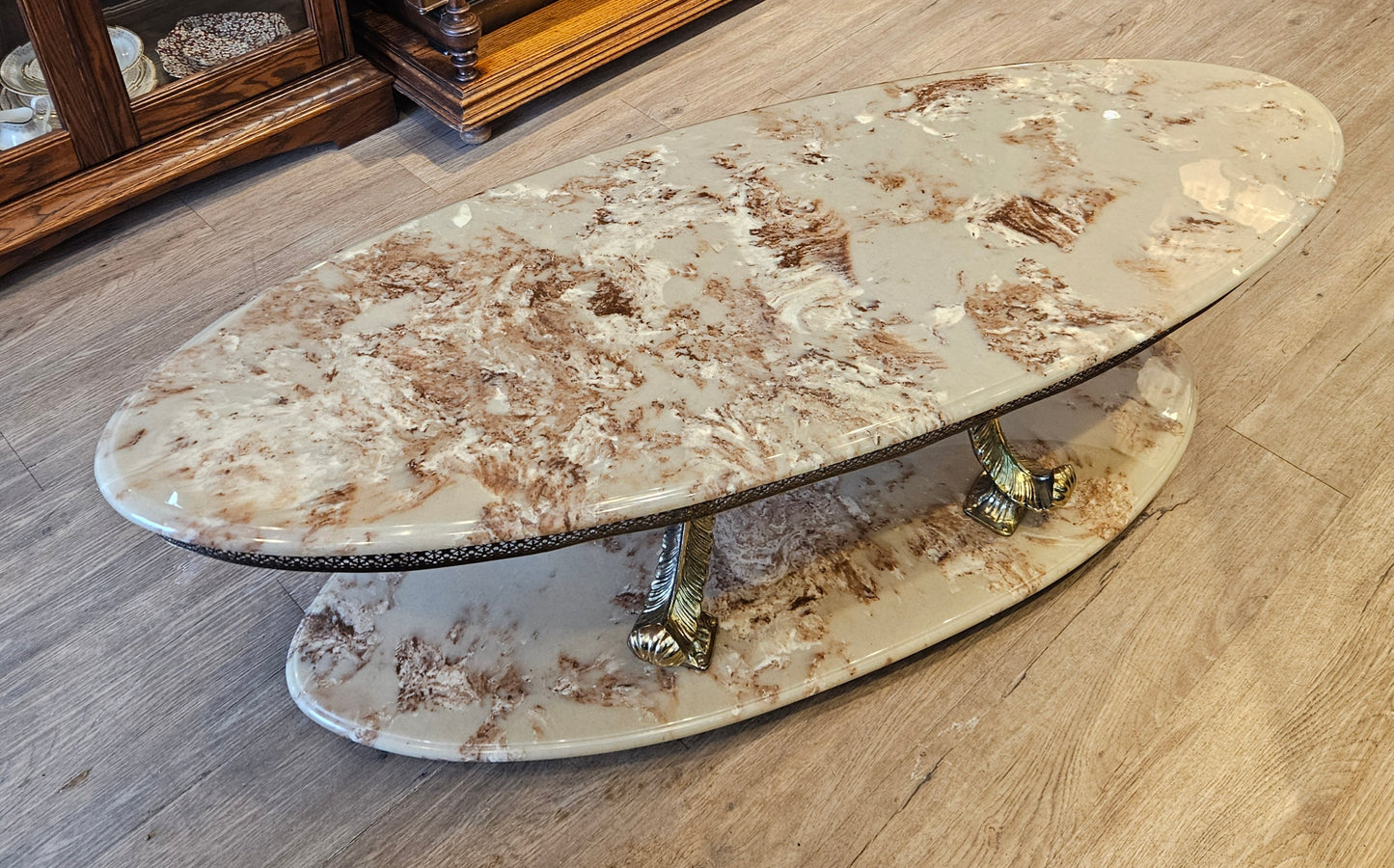 Oval coffee table, cultured marble and brass
