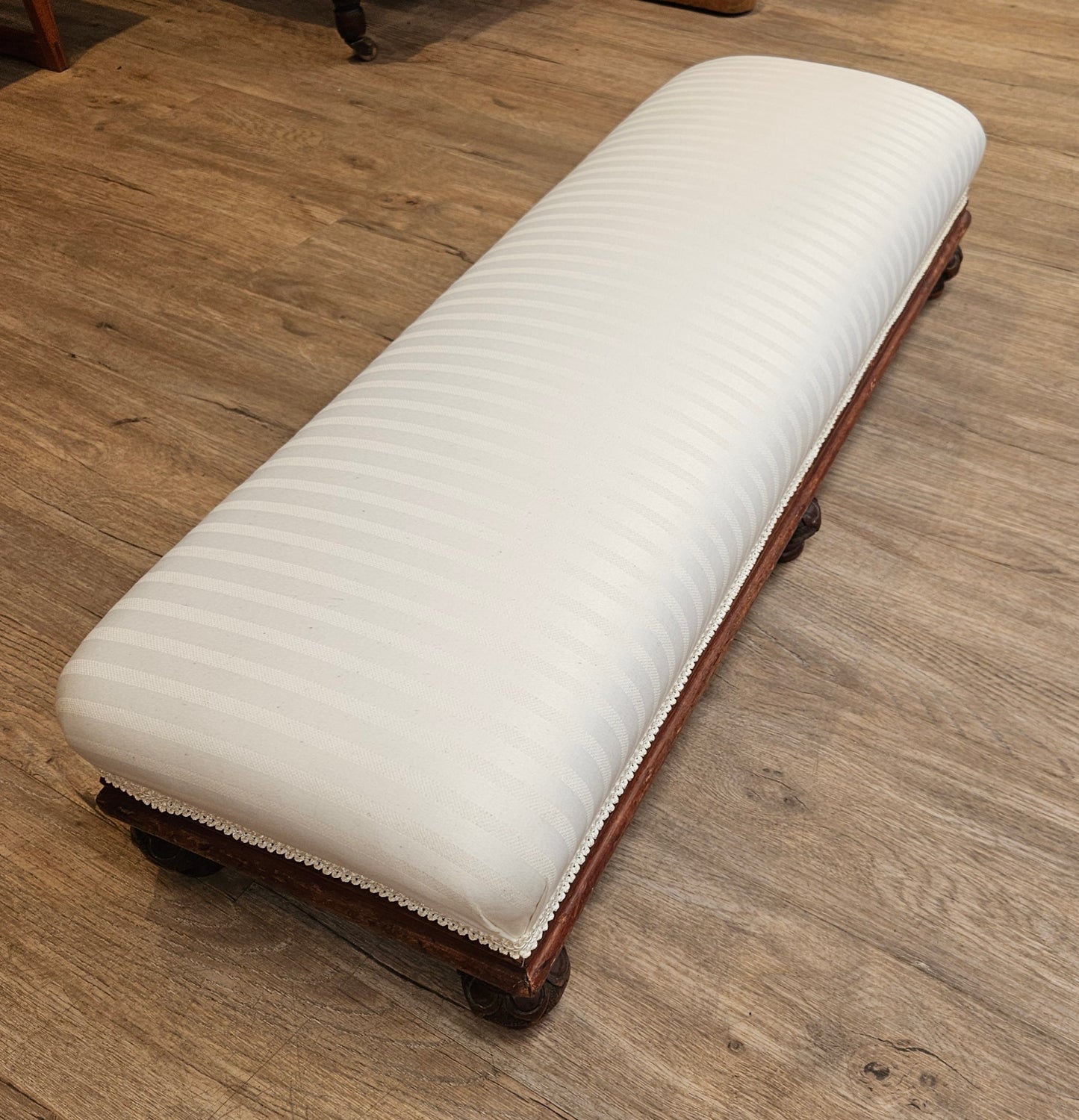 Low white upholstered fireside bench