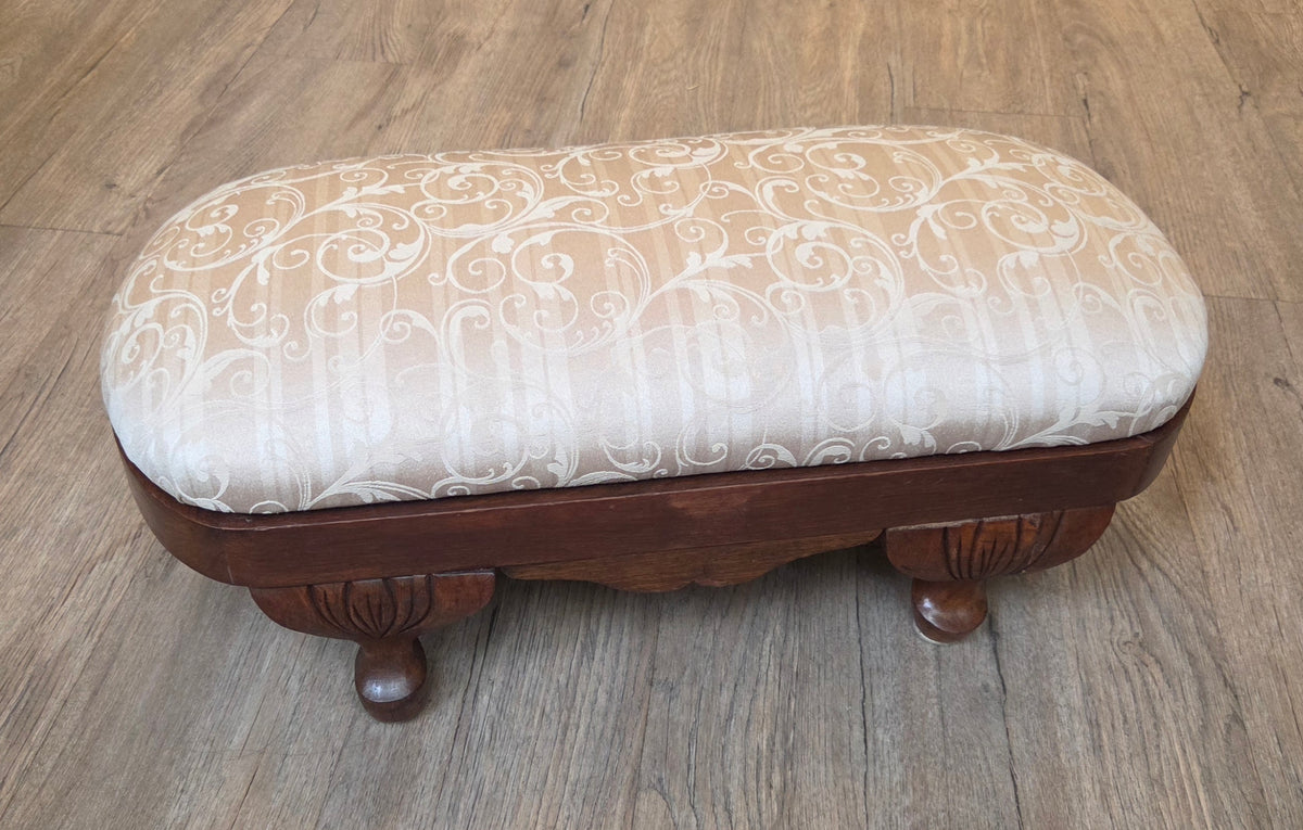 Oval antique mahogany footstool, cream coloured fabric
