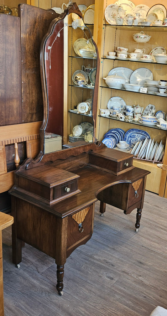 Walnut vanity with shaped mirror