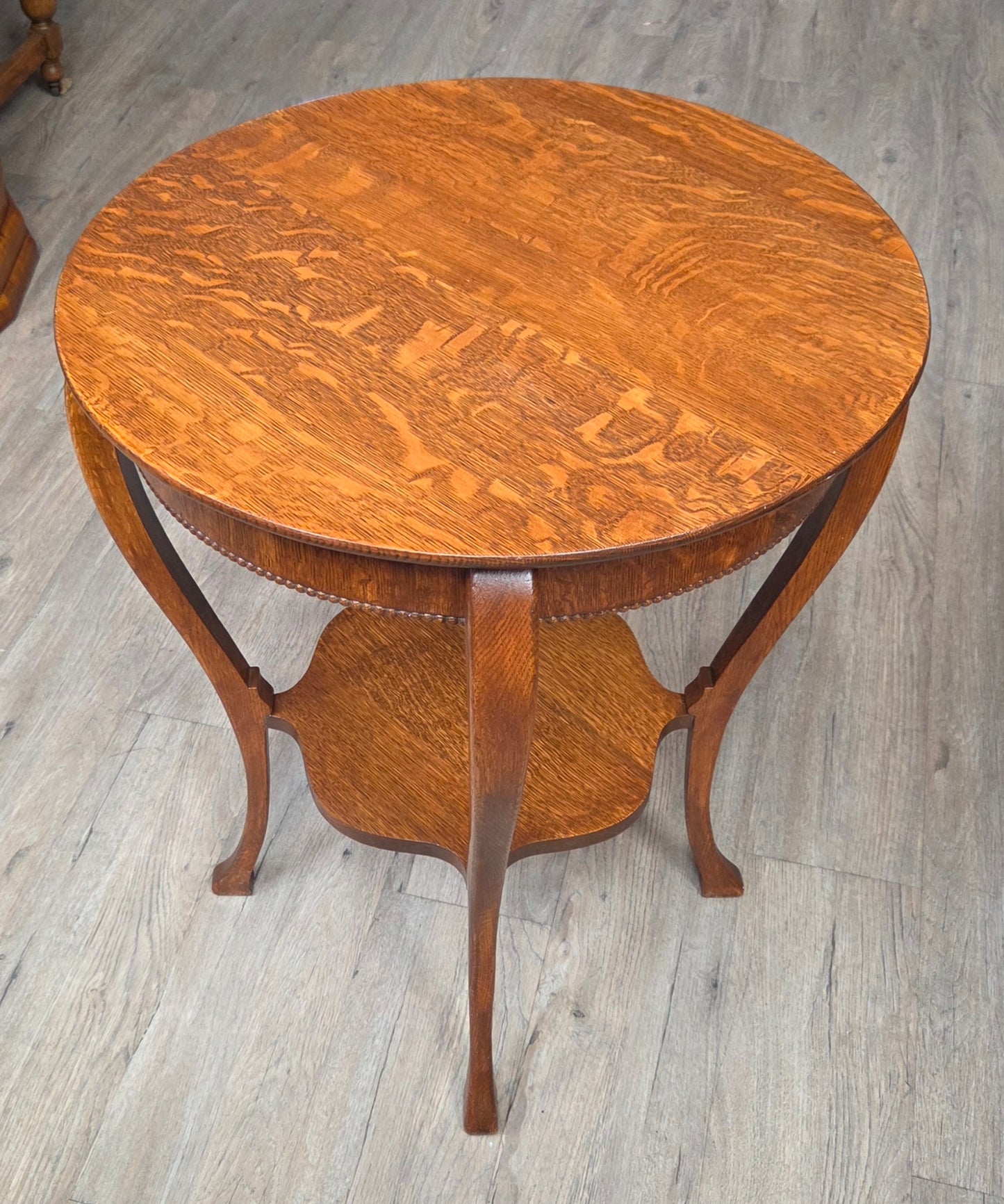 Round oak side table with shelf