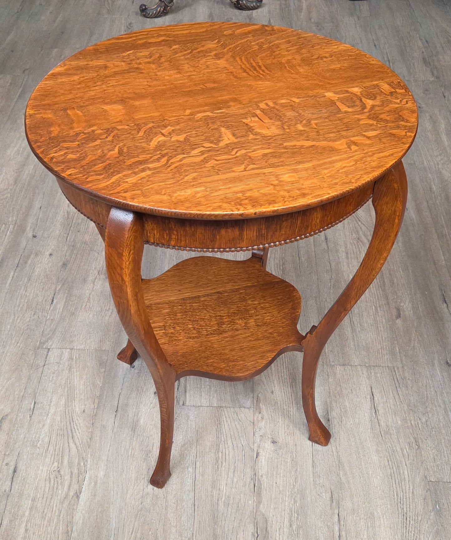 Round oak side table with shelf