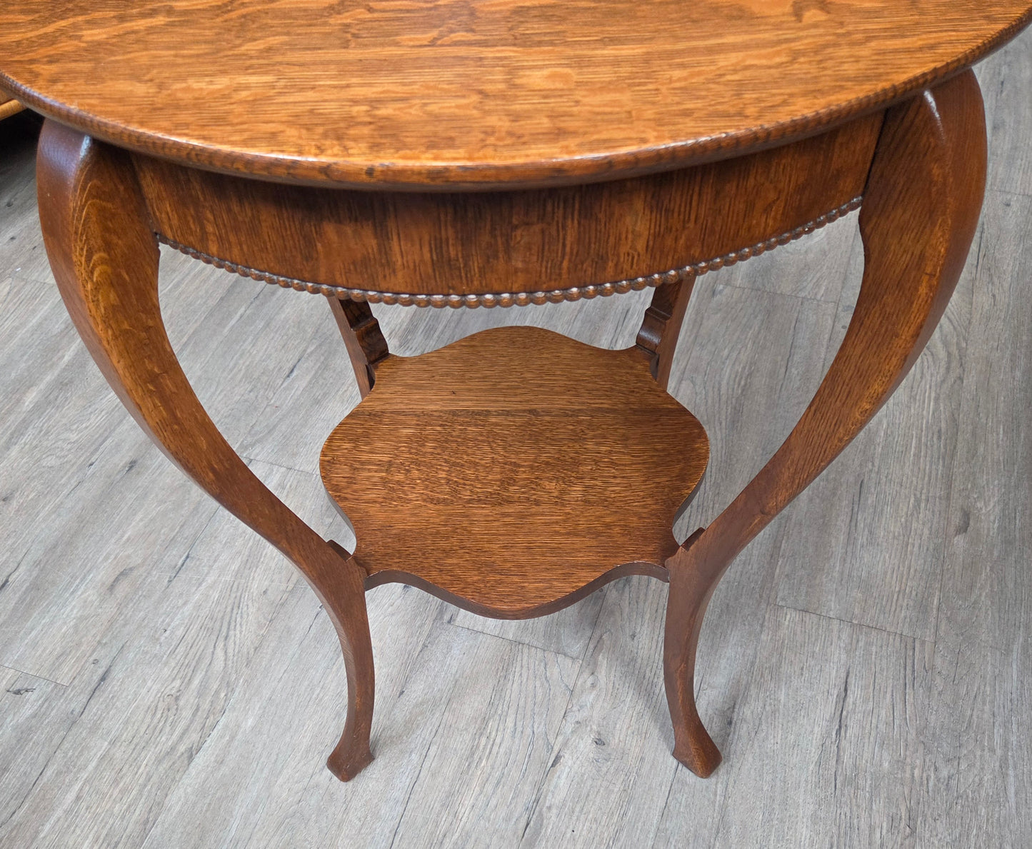 Round oak side table with shelf