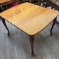 Golden oak dining table with 2 leaves, centre support legs