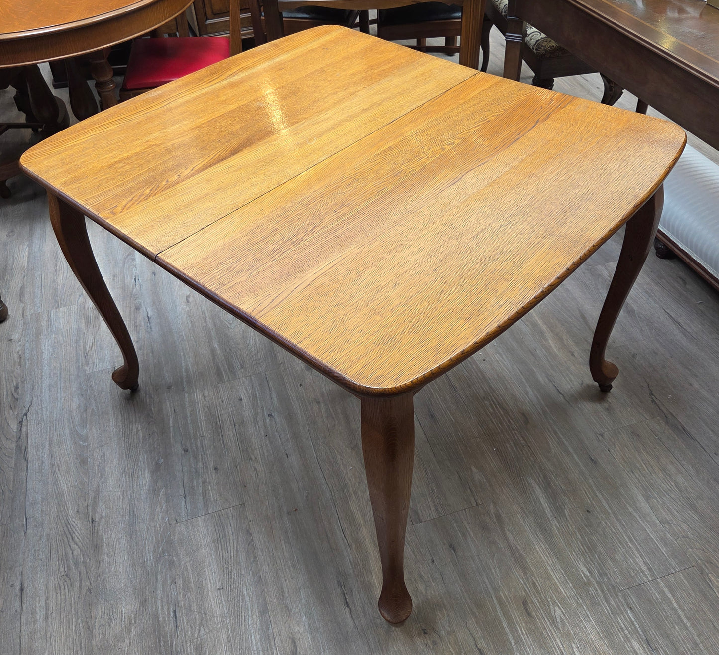 Golden oak dining table with 2 leaves, centre support legs