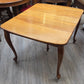 Golden oak dining table with 2 leaves, centre support legs