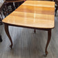 Golden oak dining table with 2 leaves, centre support legs