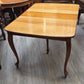 Golden oak dining table with 2 leaves, centre support legs