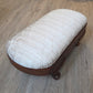 Oval antique mahogany footstool, cream coloured fabric