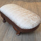 Oval antique mahogany footstool, cream coloured fabric