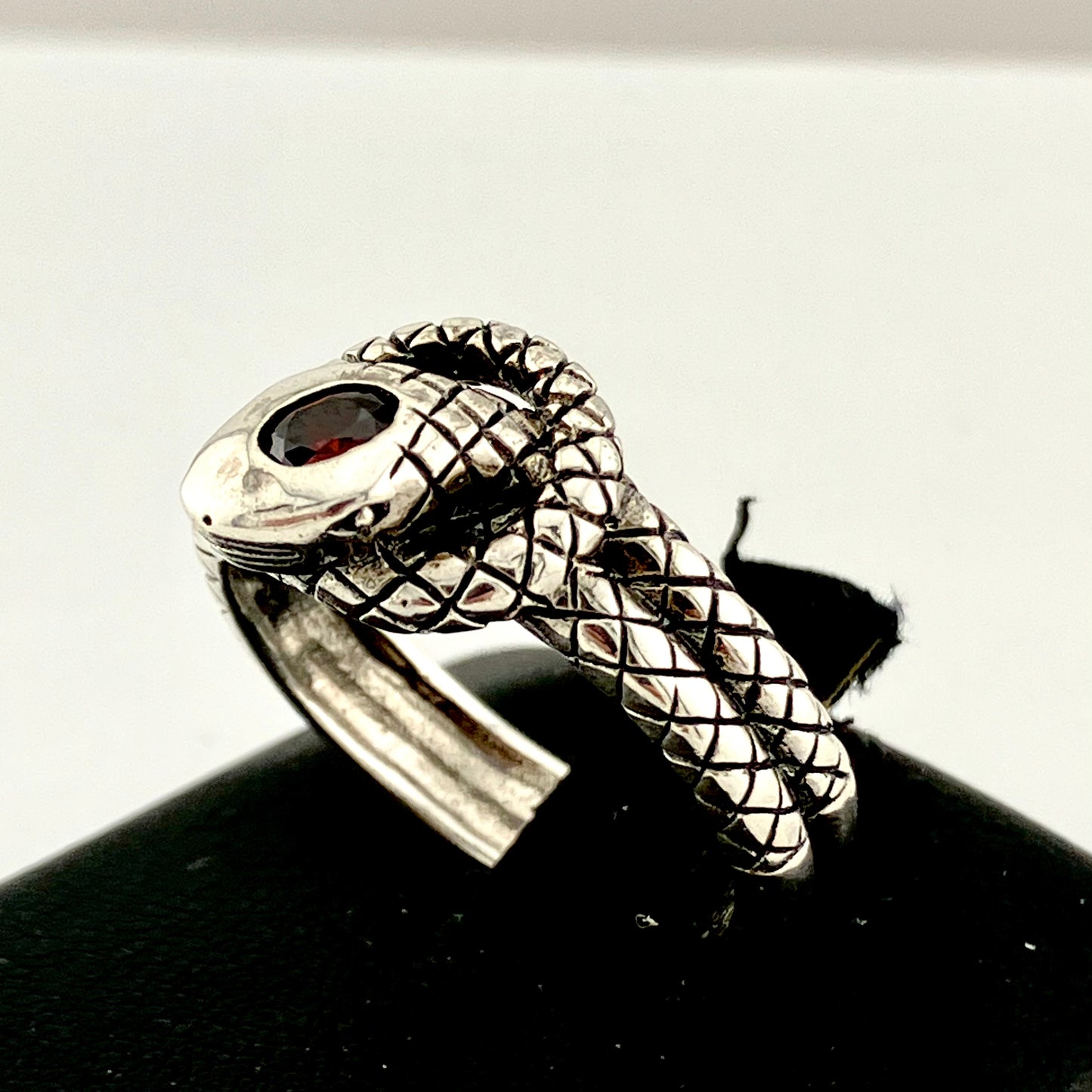 Sterling Silver Coiled and Knotted Scaled Snake Ring with Garnet Accent