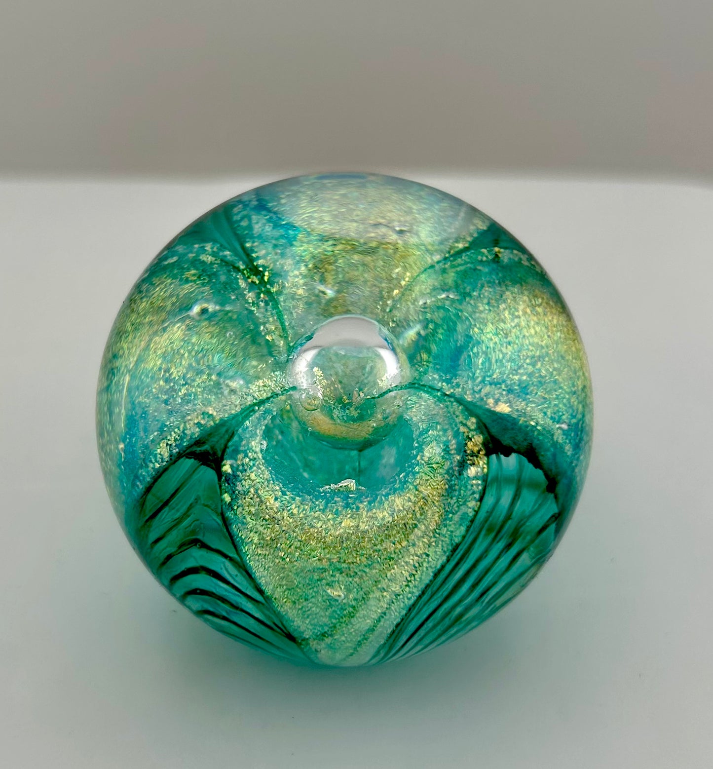 Glass Eye Studio, Glass Paperweight, Round, Iridescent gold, Aqua, Feathered Arches, with Centre Controlled Bubble