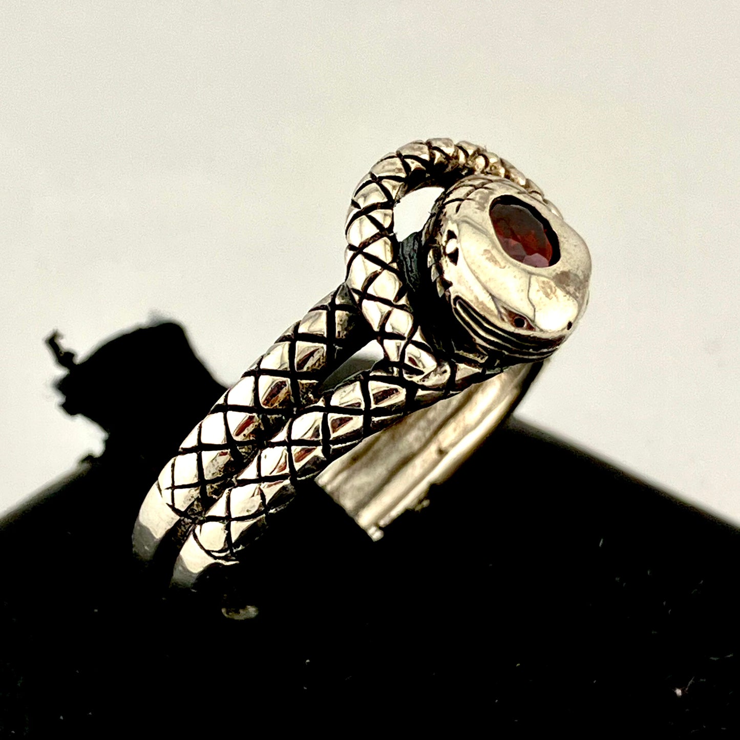 Sterling Silver Coiled and Knotted Scaled Snake Ring with Garnet Accent