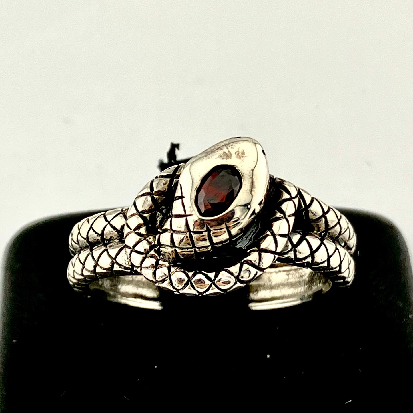 Sterling Silver Coiled and Knotted Scaled Snake Ring with Garnet Accent