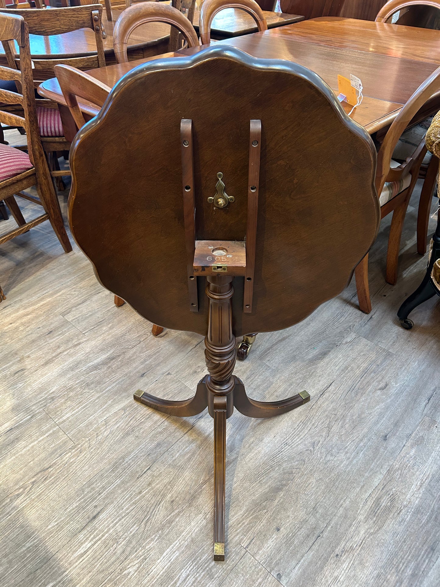 Round scalloped edge tilt top table with inlaid wood stork bird image pattern