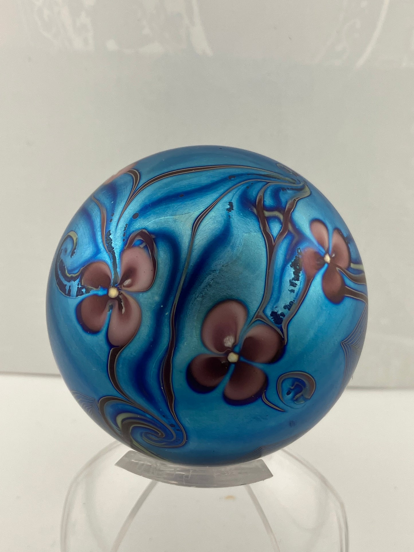 Orient and Flume Studio, Glass Paperweight, Round, Iridescent Dark Peacock Blues with Pink Flowers and Feathered Embellishment