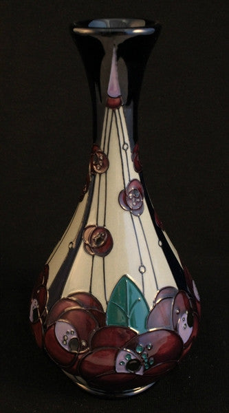 A 9 inch high vase by Moorcroft in the ''Rennie Rose'' pattern from senior Moorcroft artist, Rachel Bishop, 2015.

Inspired by the designs of art deco artist, Rennie Mackintosh.
