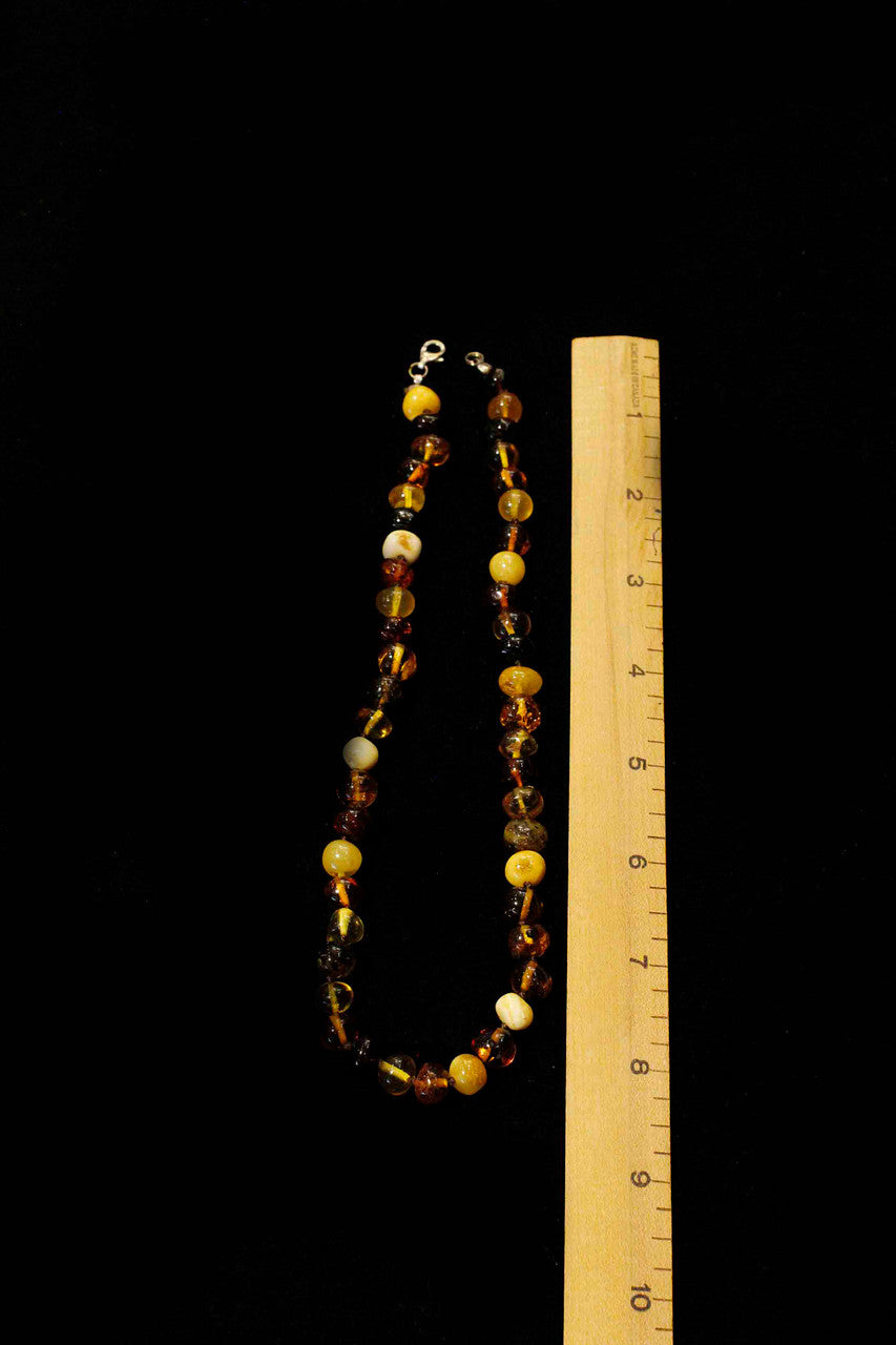 A non-vintage amber necklace fit for that someone with a unique sense of style.
Measuring eighteen inches long this hand knotted string of beautiful multicolored irregular amber beads is finished with a 925 silver lobster clasp to make it easy to slip on and off for the day.

Originated from Poland (Baltic), best quality natural amber.

These amber beads measure ~10mm or less.

JN58490